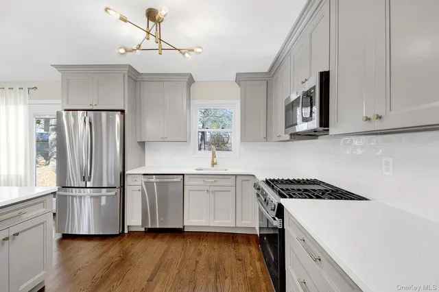 a kitchen with stainless steel appliances a refrigerator sink and cabinets