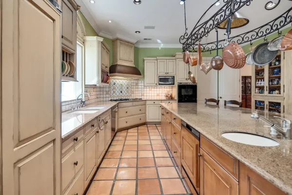 a kitchen with stainless steel appliances granite countertop a sink and cabinets