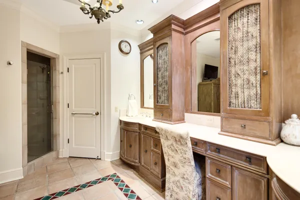 a bathroom with a sink mirror and a bathtub next to a window
