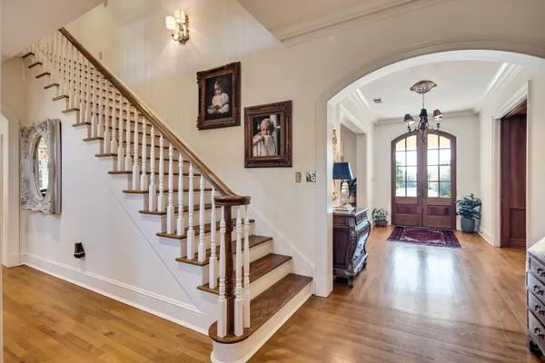 a view of entryway and hall with wooden floor