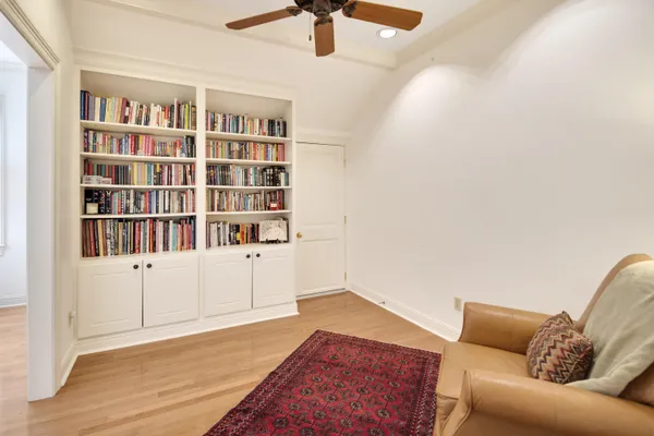 a living room with furniture and a book shelf