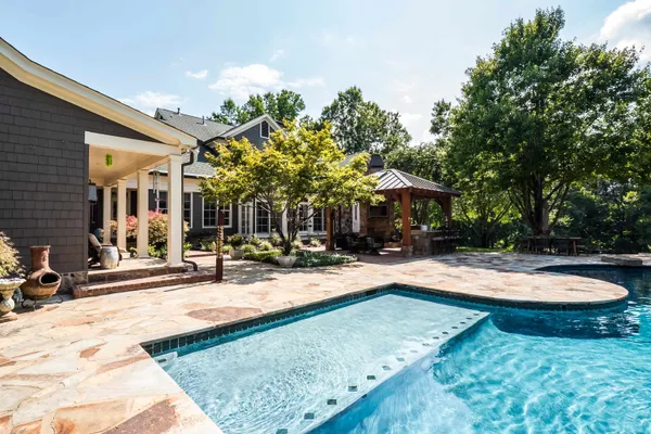 a view of a house with yard and sitting area