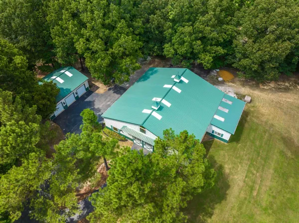 an aerial view of a house with a yard