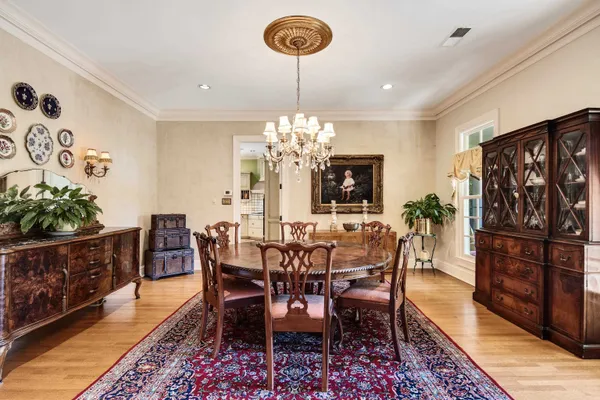 a view of a dining room with furniture and chandelier