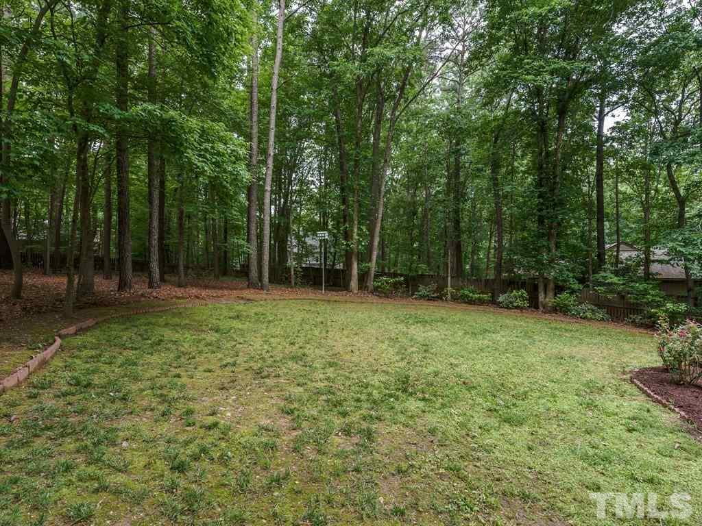 505 Hi Bridge Court Raleigh, NC 27615 - Photo 22 of 25 a backyard of a house with lots of green space