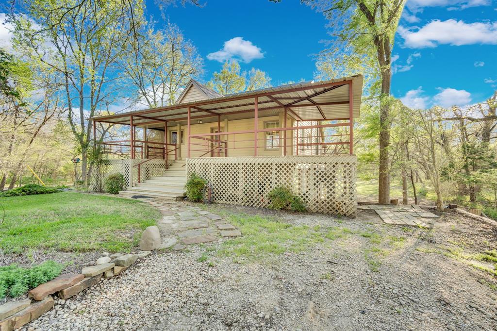 488 Loma Linda Road Palmer, TX 75152 - Photo 17 of 39 a view of a house with a back yard