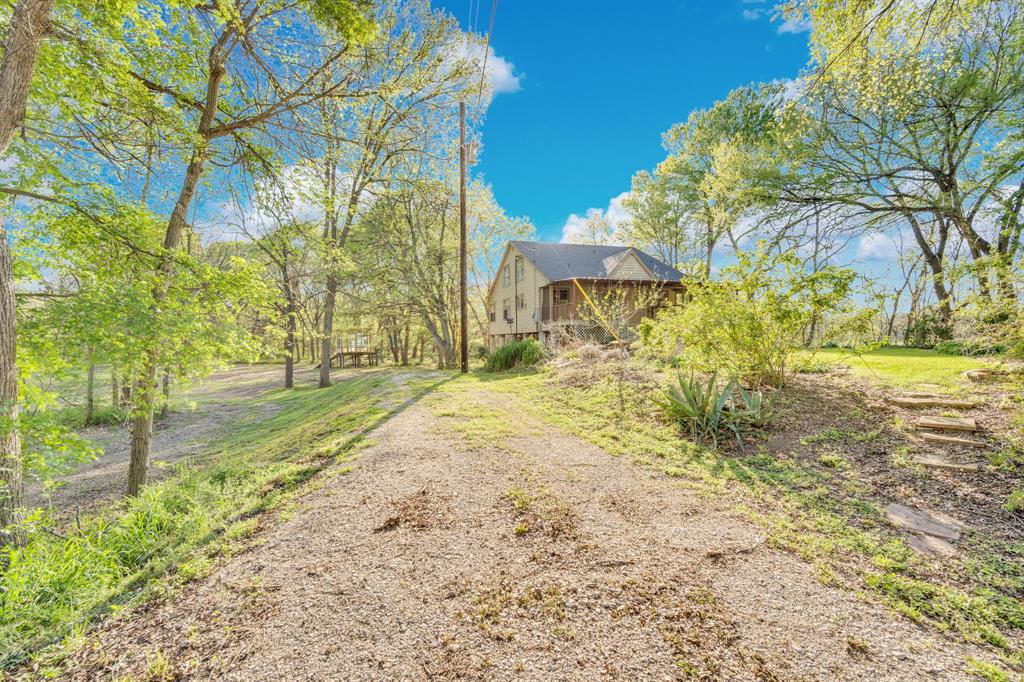 488 Loma Linda Road Palmer, TX 75152 - Photo 18 of 39 a view of a yard with plants and trees
