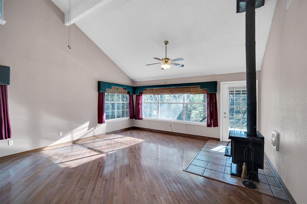 488 Loma Linda Road Palmer, TX 75152 - Photo 22 of 39 a view of an empty room with wooden floor and a window