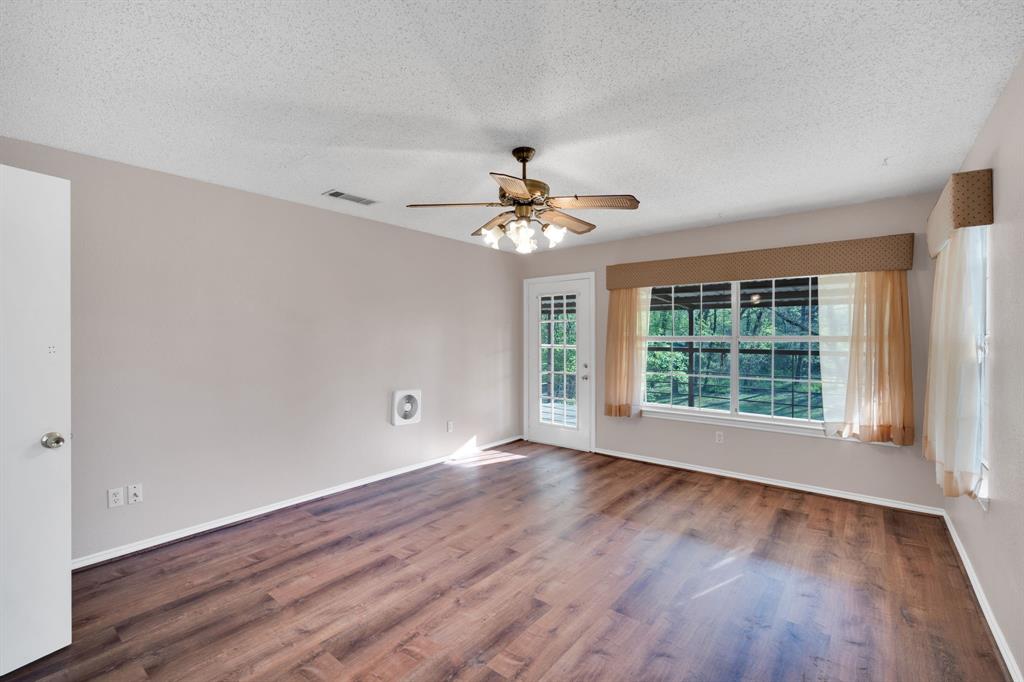 488 Loma Linda Road Palmer, TX 75152 - Photo 27 of 39 a view of an empty room with wooden floor and a window