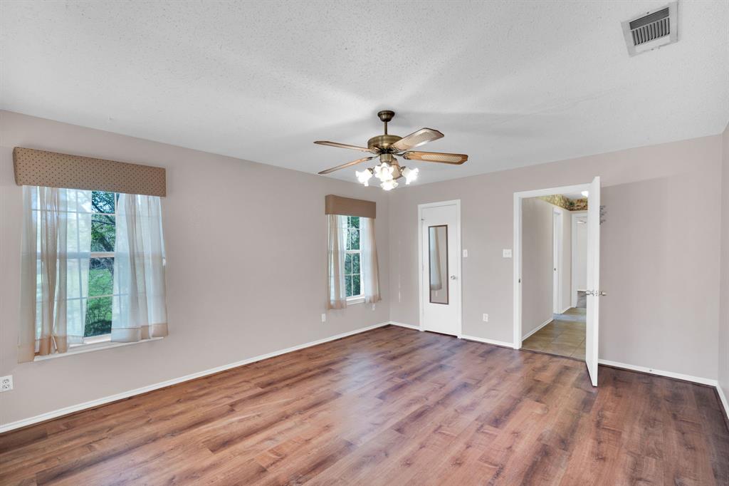 488 Loma Linda Road Palmer, TX 75152 - Photo 28 of 39 a view of an empty room with wooden floor and a window