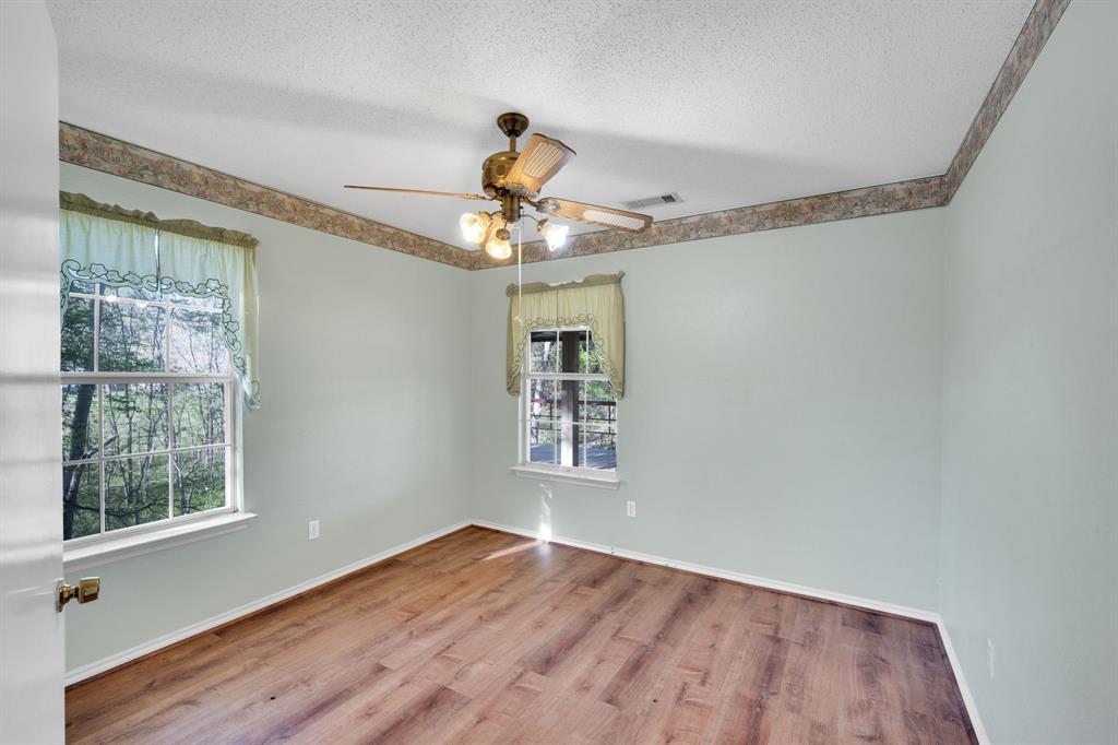 488 Loma Linda Road Palmer, TX 75152 - Photo 30 of 39 a view of an empty room with wooden floor and a window