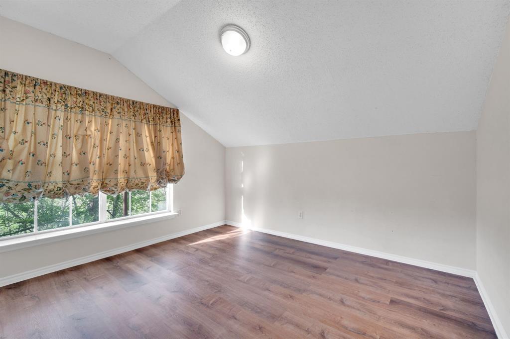 488 Loma Linda Road Palmer, TX 75152 - Photo 34 of 39 an empty room with wooden floor and windows