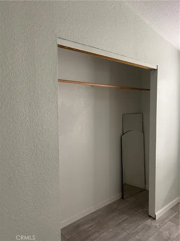 an empty room with wooden floor and closet