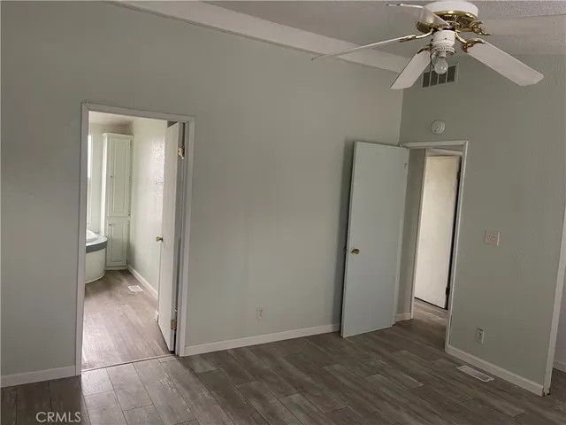 a bathroom with a granite countertop sink toilet and mirror
