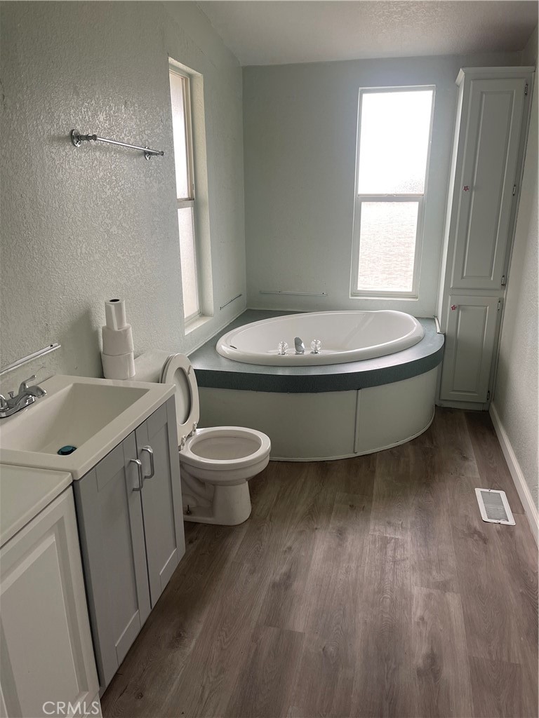 33137 Haddock Street Winchester, CA 92596 - Photo 20 of 32 a bathroom with a granite countertop sink toilet and mirror