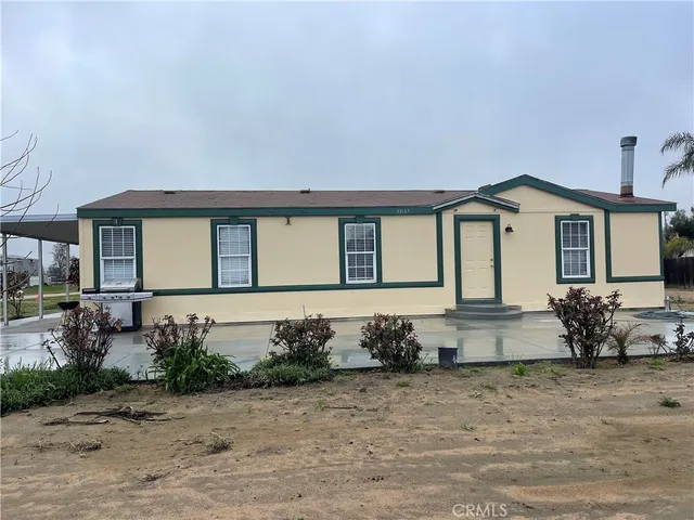 a front view of a house with sitting area