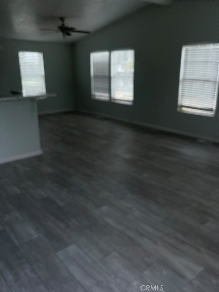 33137 Haddock Street Winchester, CA 92596 - Photo 8 of 32 an empty room with wooden floor and windows