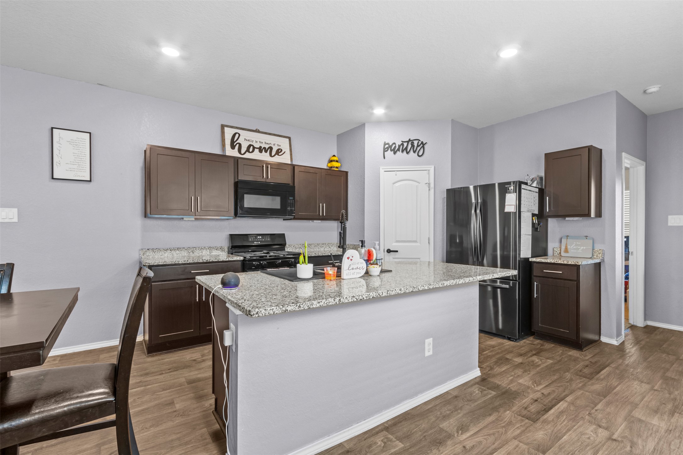 339 Euclid Lane Kyle, TX 78640 - Photo 10 of 17 a kitchen with kitchen island a refrigerator stove microwave and sink