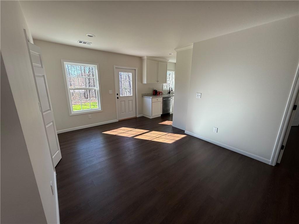 275 Red Oak Flats Road Dahlonega, GA 30533 - Photo 3 of 16 an empty room with wooden floor and windows
