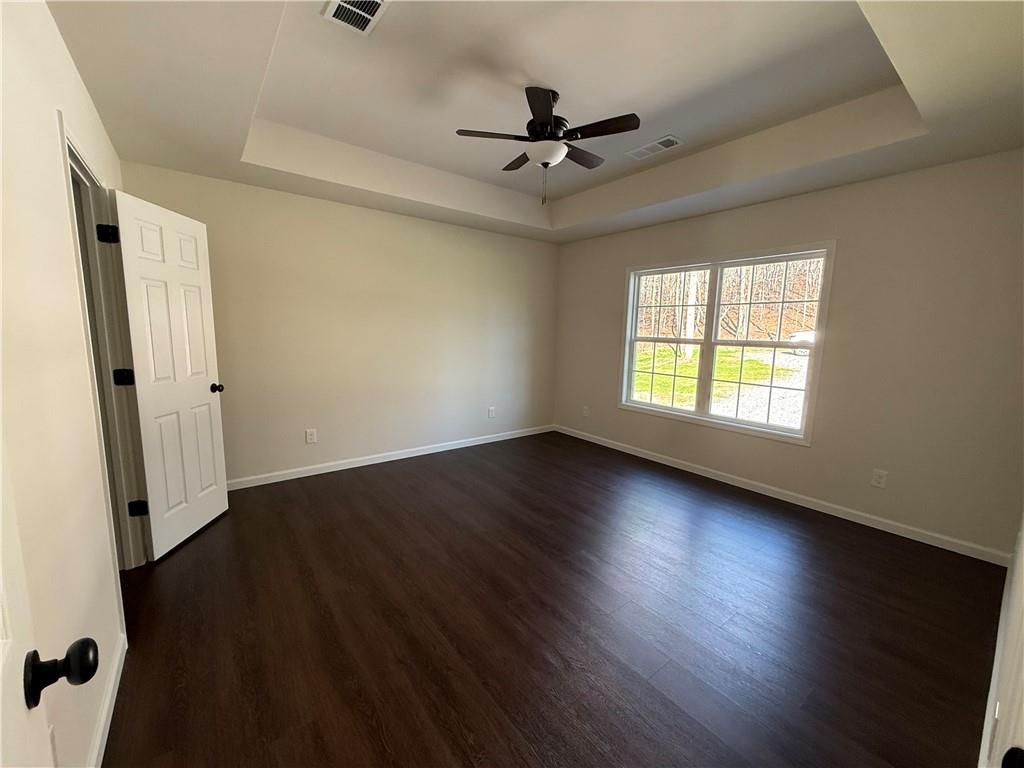 275 Red Oak Flats Road Dahlonega, GA 30533 - Photo 5 of 16 a view of an empty room with wooden floor and a window