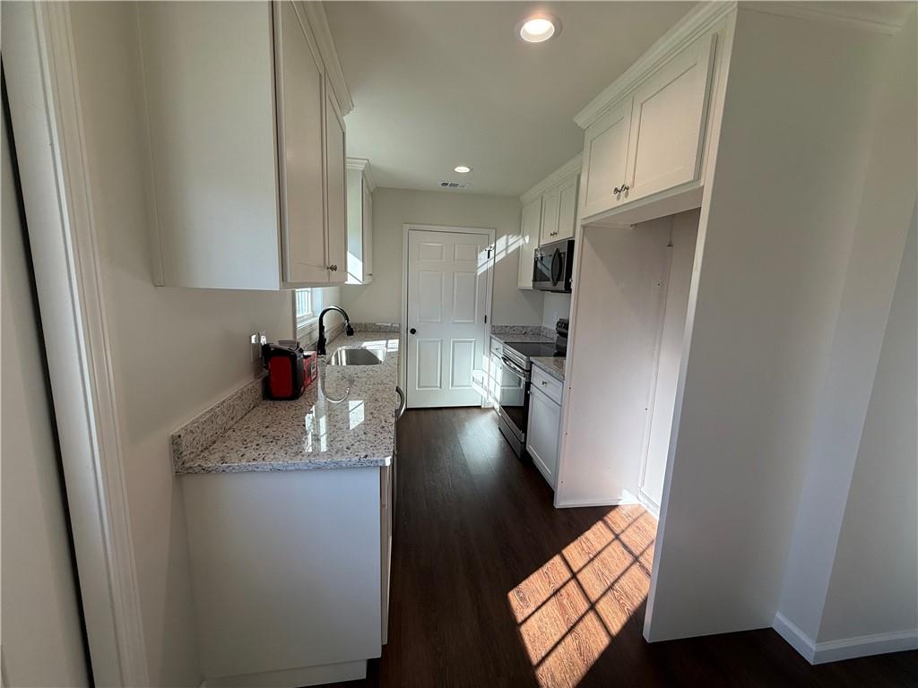 275 Red Oak Flats Road Dahlonega, GA 30533 - Photo 7 of 16 a kitchen with stainless steel appliances a sink stove and refrigerator