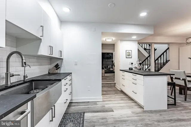 a kitchen with stainless steel appliances granite countertop a stove a sink and a granite counter tops