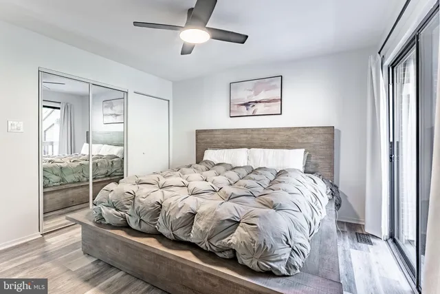 a bedroom with a bed and glass window