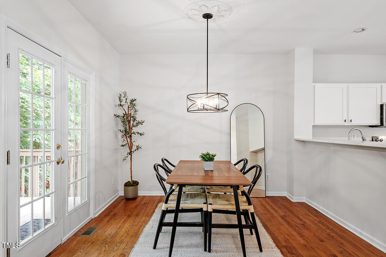 12601 Waterlow Park Lane Raleigh, NC 27614 - Photo 12 of 38 a view of a dining room with furniture window and wooden floor
