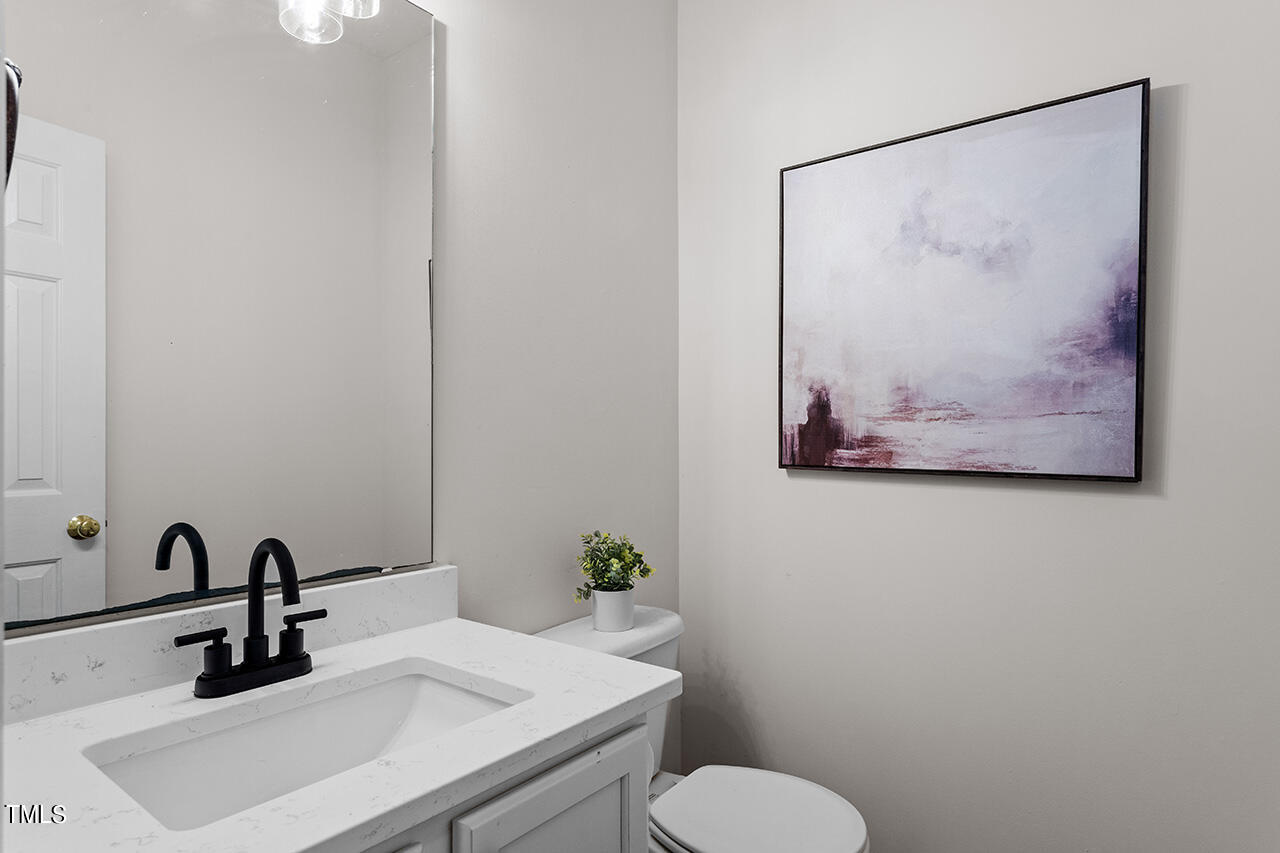 12601 Waterlow Park Lane Raleigh, NC 27614 - Photo 17 of 38 a bathroom with a sink mirror and toilet