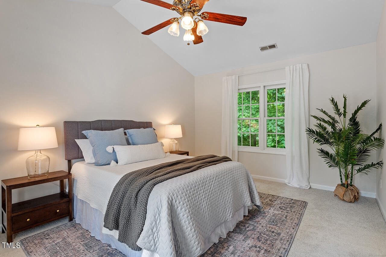 12601 Waterlow Park Lane Raleigh, NC 27614 - Photo 20 of 38 a bedroom with bed and a chandelier