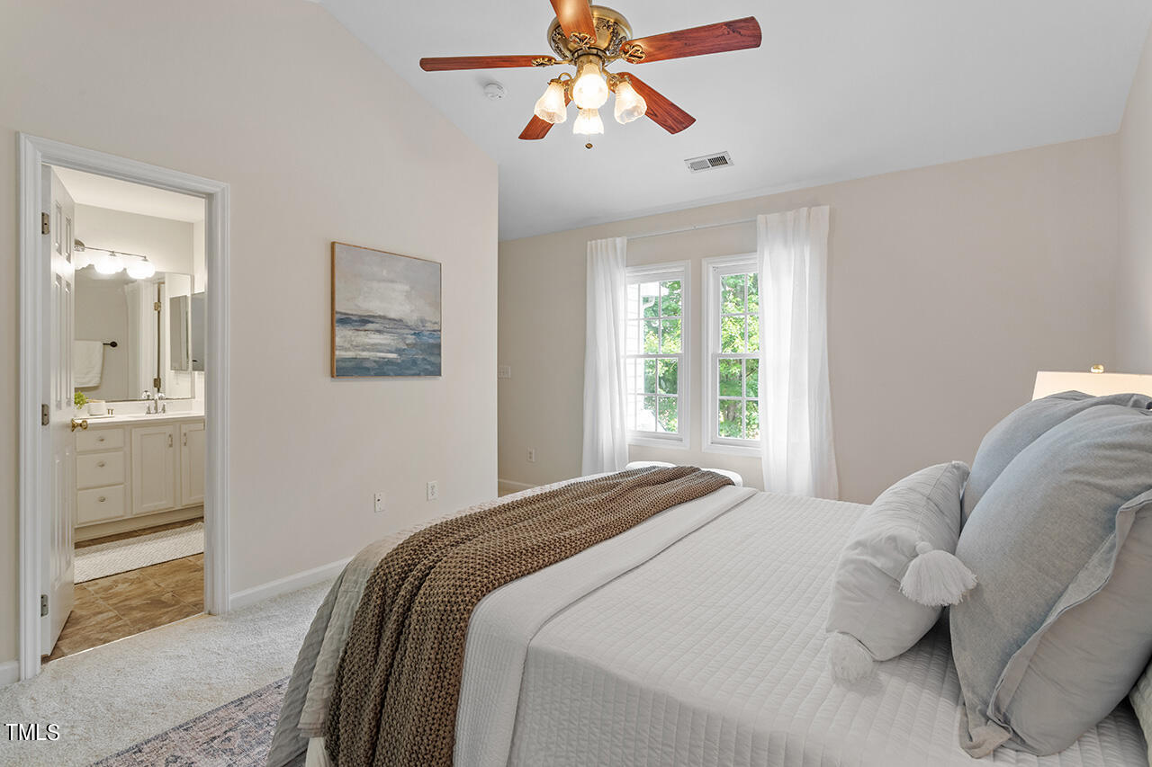 12601 Waterlow Park Lane Raleigh, NC 27614 - Photo 21 of 38 a bedroom with a bed and a painting on the wall
