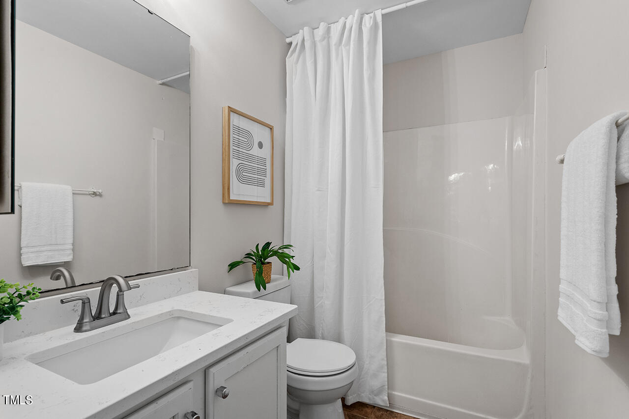 12601 Waterlow Park Lane Raleigh, NC 27614 - Photo 27 of 38 a bathroom with a sink toilet and vanity