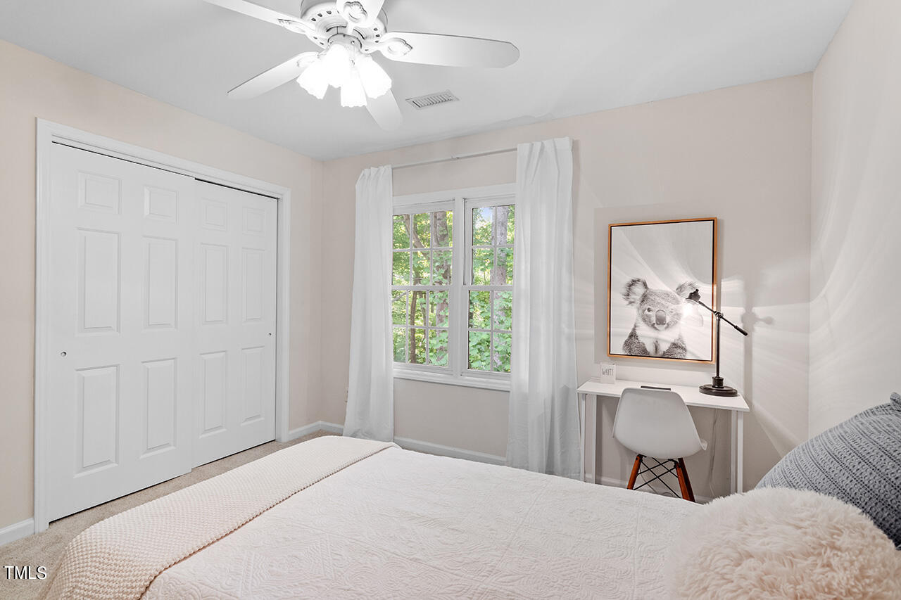 12601 Waterlow Park Lane Raleigh, NC 27614 - Photo 29 of 38 a bedroom with a bed and a chandelier