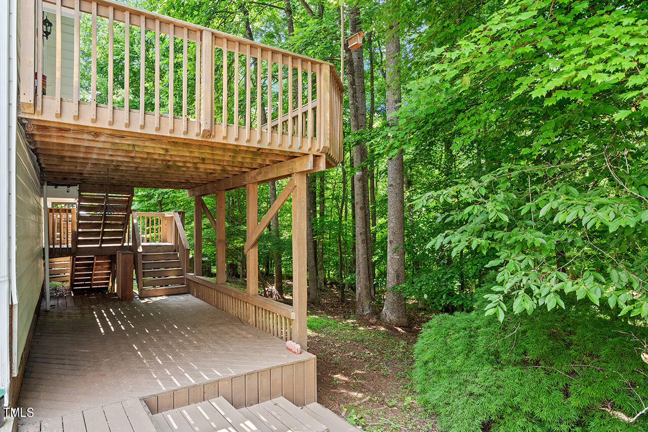 12601 Waterlow Park Lane Raleigh, NC 27614 - Photo 34 of 38 a view of a patio with table and chairs with wooden floor and fence