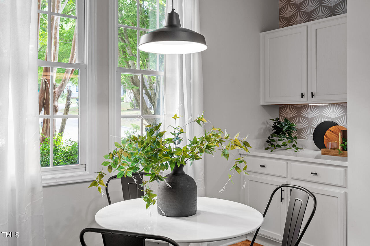 12601 Waterlow Park Lane Raleigh, NC 27614 - Photo 5 of 38 a view of a dining table with a potted plant