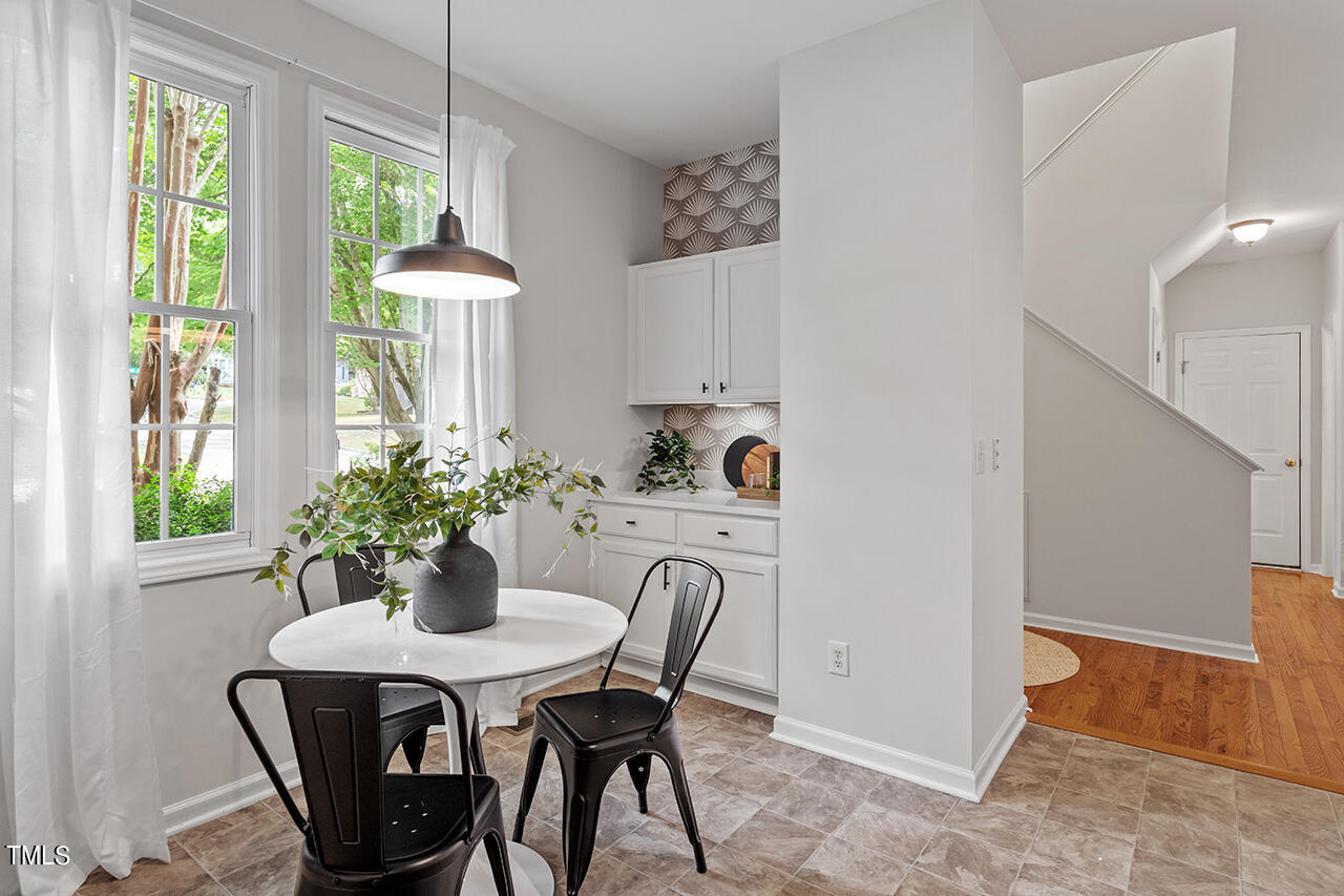 12601 Waterlow Park Lane Raleigh, NC 27614 - Photo 6 of 38 a dining room with furniture potted plants and wooden floor