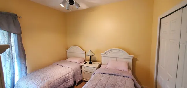 a bedroom with a bed and a painting on the wall