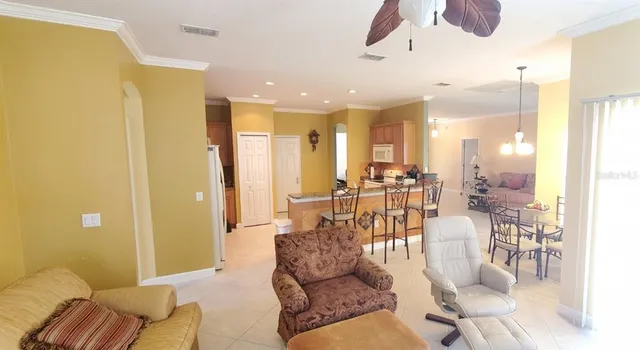 a living room with furniture wooden floor and a chandelier