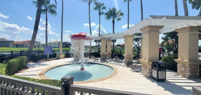 a view of a house with swimming pool and sitting area
