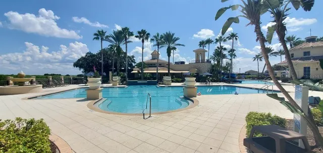 a swimming pool with outdoor seating and yard