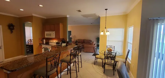 a view of a dining room with furniture window and outside view