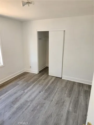 an empty room with wooden floor