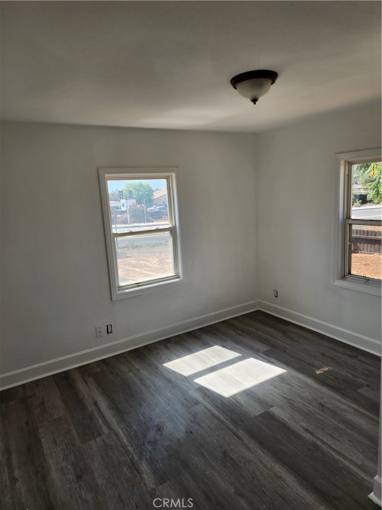6420 Stover Avenue Riverside, CA 92505 - Photo 3 of 13 an empty room with wooden floor and windows