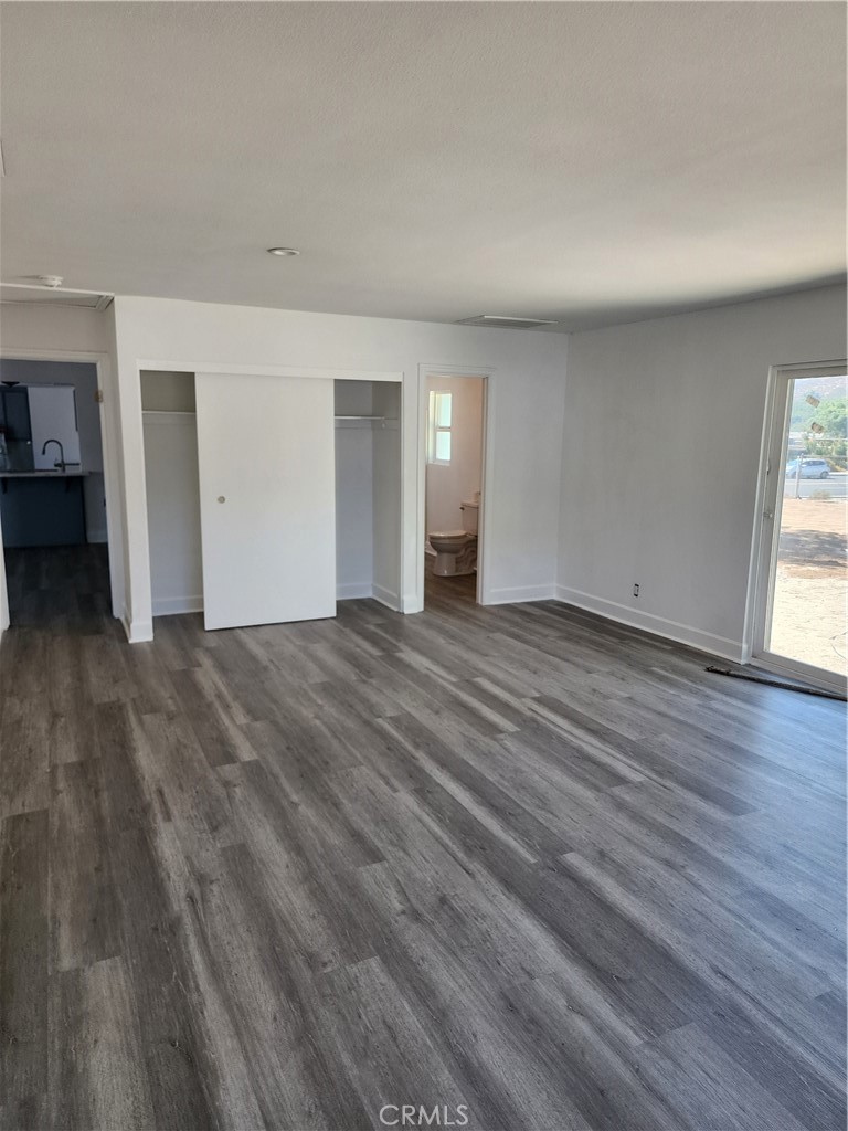 6420 Stover Avenue Riverside, CA 92505 - Photo 6 of 13 a view of an empty room with wooden floor and a window