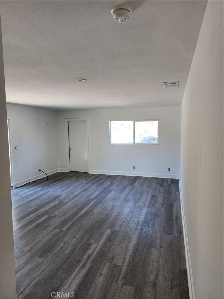 6420 Stover Avenue Riverside, CA 92505 - Photo 8 of 13 an empty room with wooden floor and windows