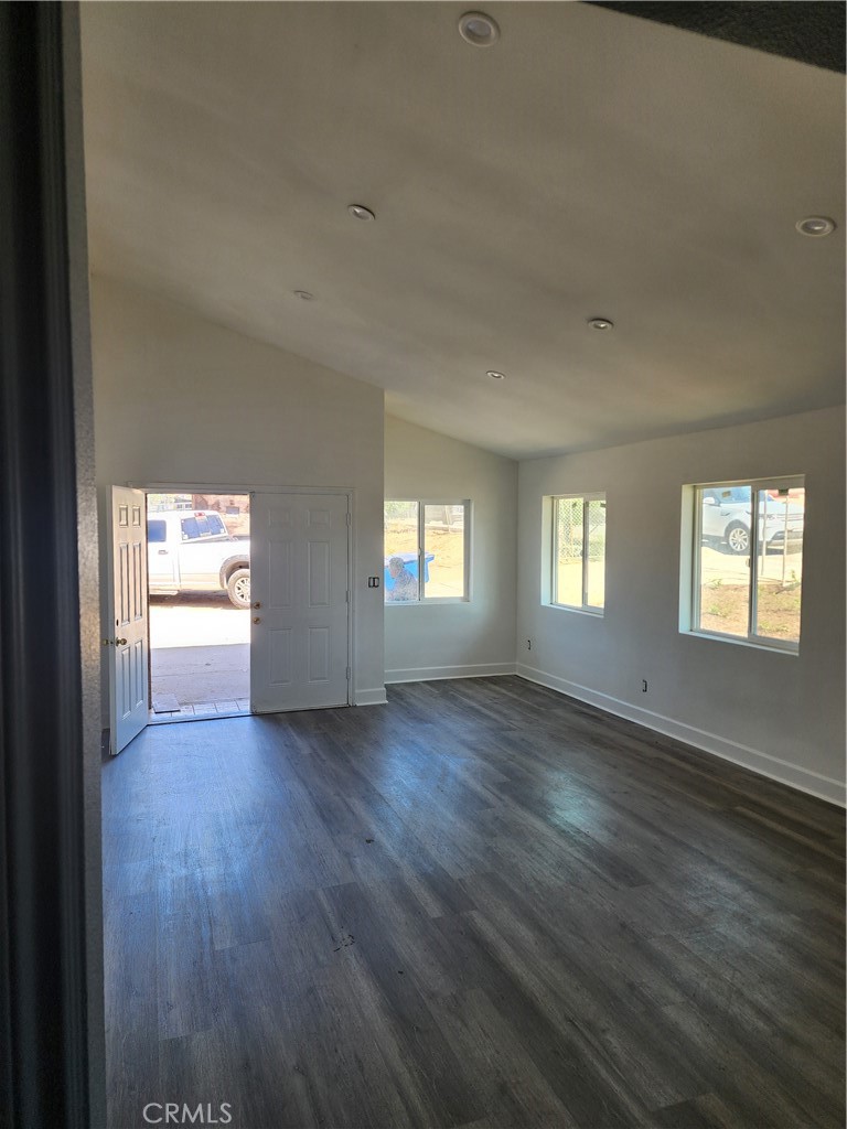 6420 Stover Avenue Riverside, CA 92505 - Photo 9 of 13 an empty room with wooden floor and windows