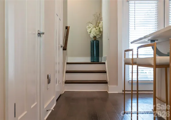 a view of staircase with white walls and a window