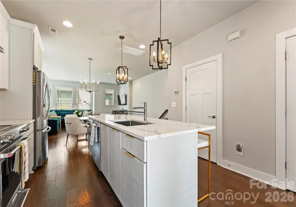 a kitchen with a sink a stove and a refrigerator