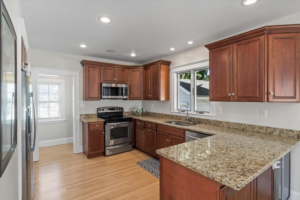 35 Clinton Road Weymouth, MA 02189 - Photo 12 of 37 a kitchen with stainless steel appliances granite countertop wooden cabinets a stove top oven and granite counter top