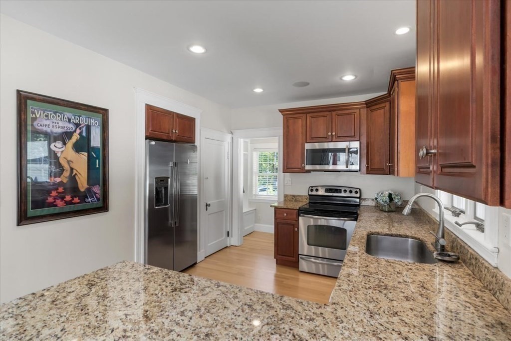 35 Clinton Road Weymouth, MA 02189 - Photo 13 of 37 a kitchen with stainless steel appliances granite countertop a refrigerator a stove top oven a sink and dishwasher